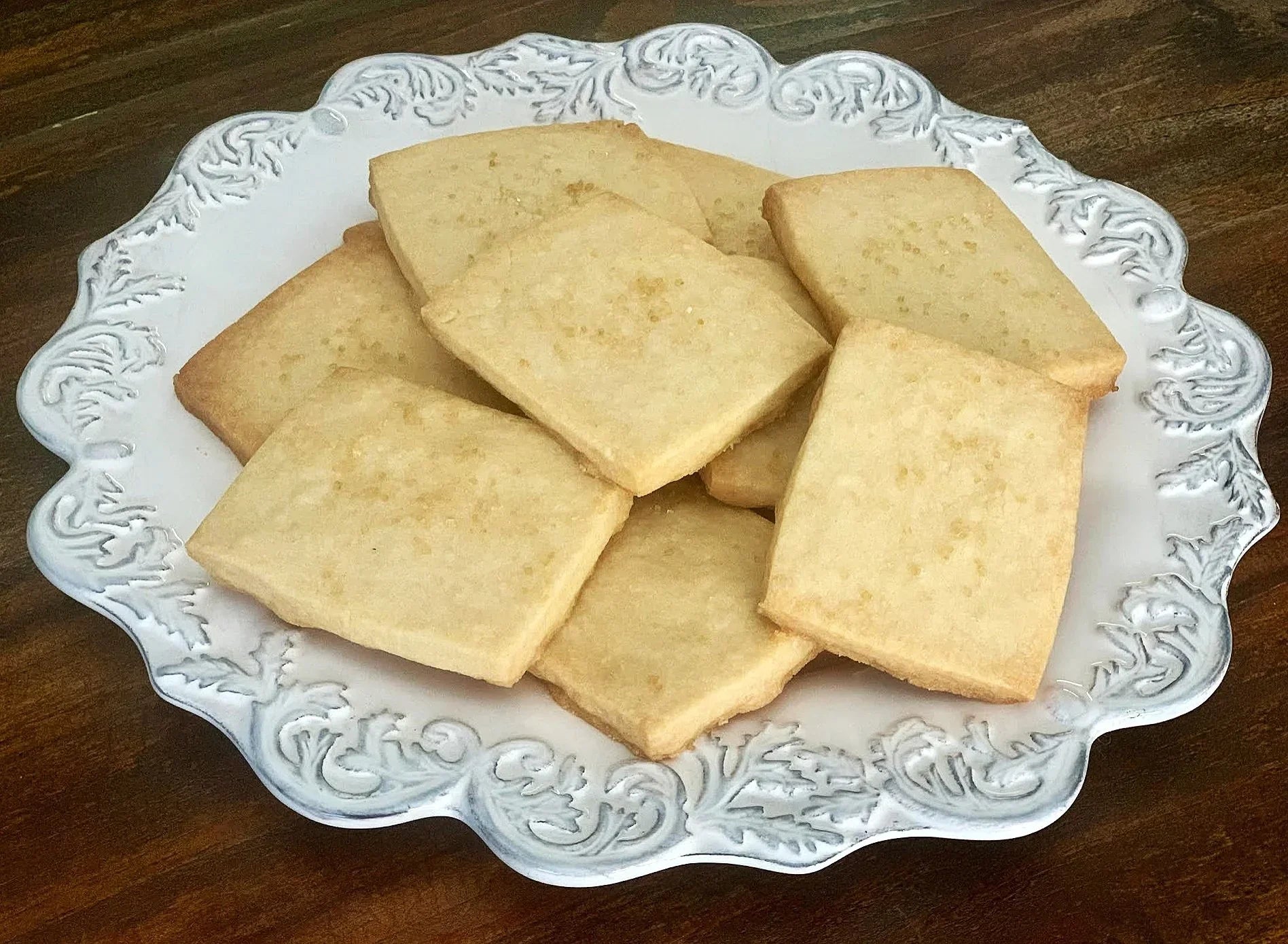 Delicious VANILLA SHORTBREAD COOKIES arranged on an elegant white plate, perfect for any occasion.